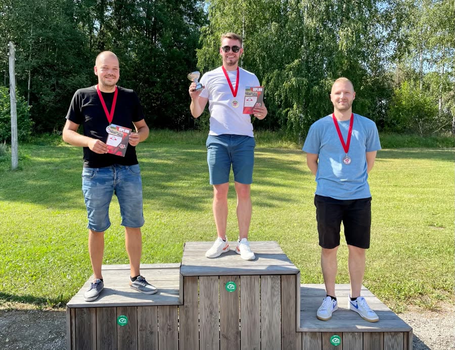 Three of the Finceptiv team on a podium with medals
